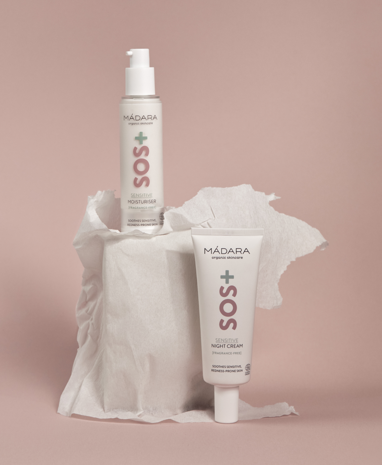 MÁDARA SOS+ Sensitive moisturiser and night cream displayed on a soft pink background with textured paper props
