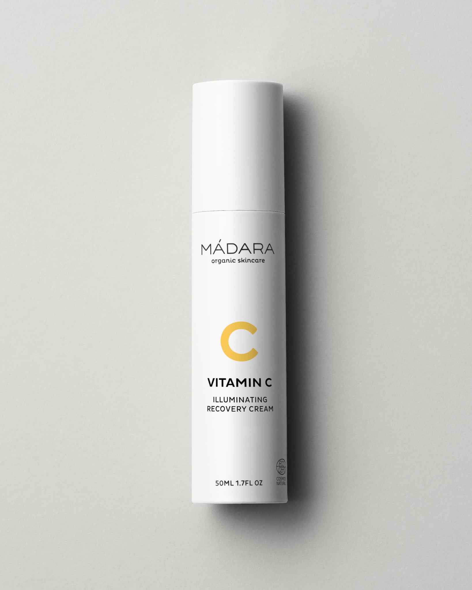 Mádara Vitamin C Illuminating Recovery Cream bottle on a gray background