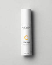 Mádara Vitamin C Illuminating Recovery Cream bottle on a gray background