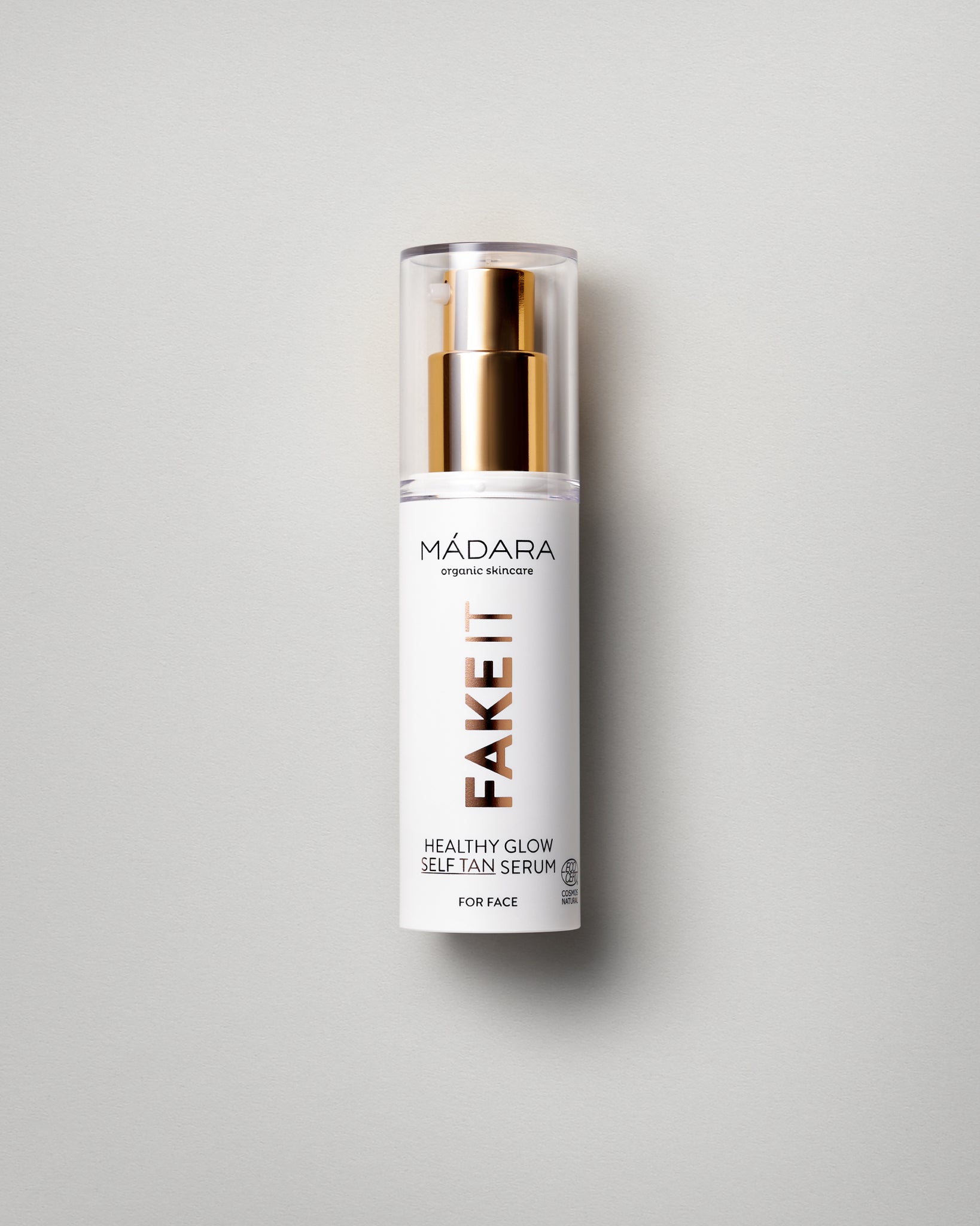 Model wearing MÁDARA Organic Skincare healthy glow self tan serum for face A3421 serum on skin; close-up portrait shows natural application results.
