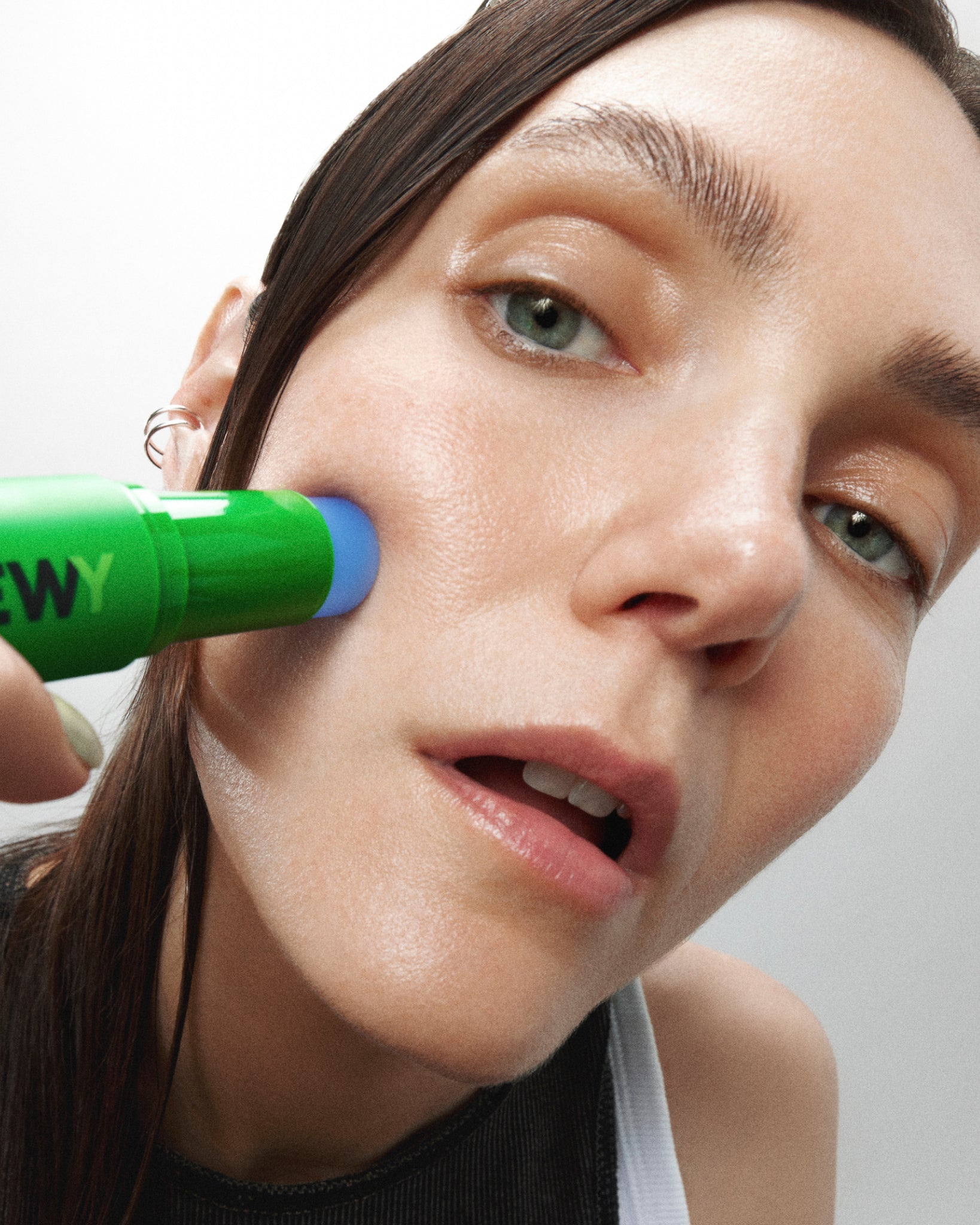 MADARA DEWY caffeine face serum stick on female model