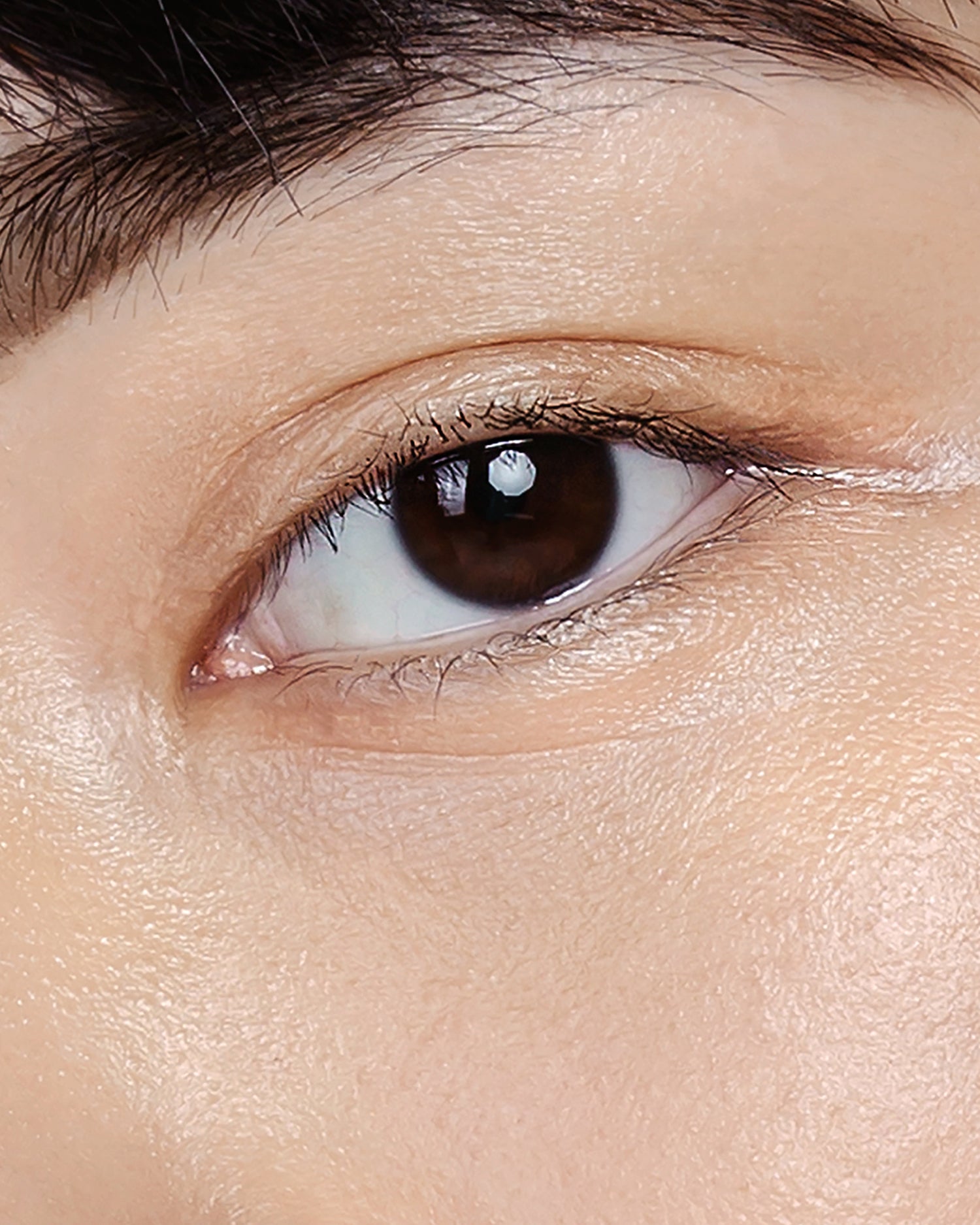 Model wearing MÁDARA Organic Skincare the concealer honey on A6102 concealer on skin; close-up portrait shows natural application results.