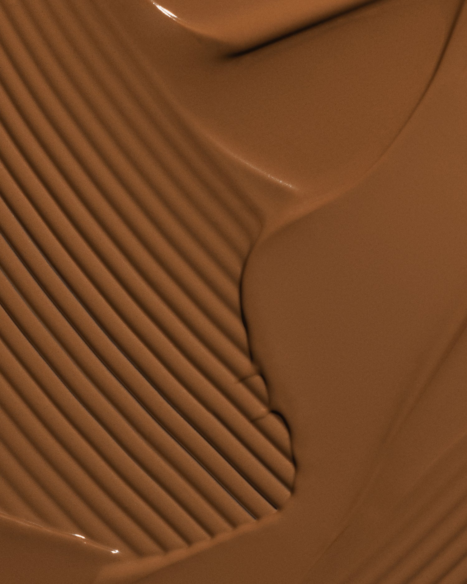 Texture close-up of MÁDARA Organic Skincare skinonym auburn A6094 �swatch demonstrates consistency and finish.