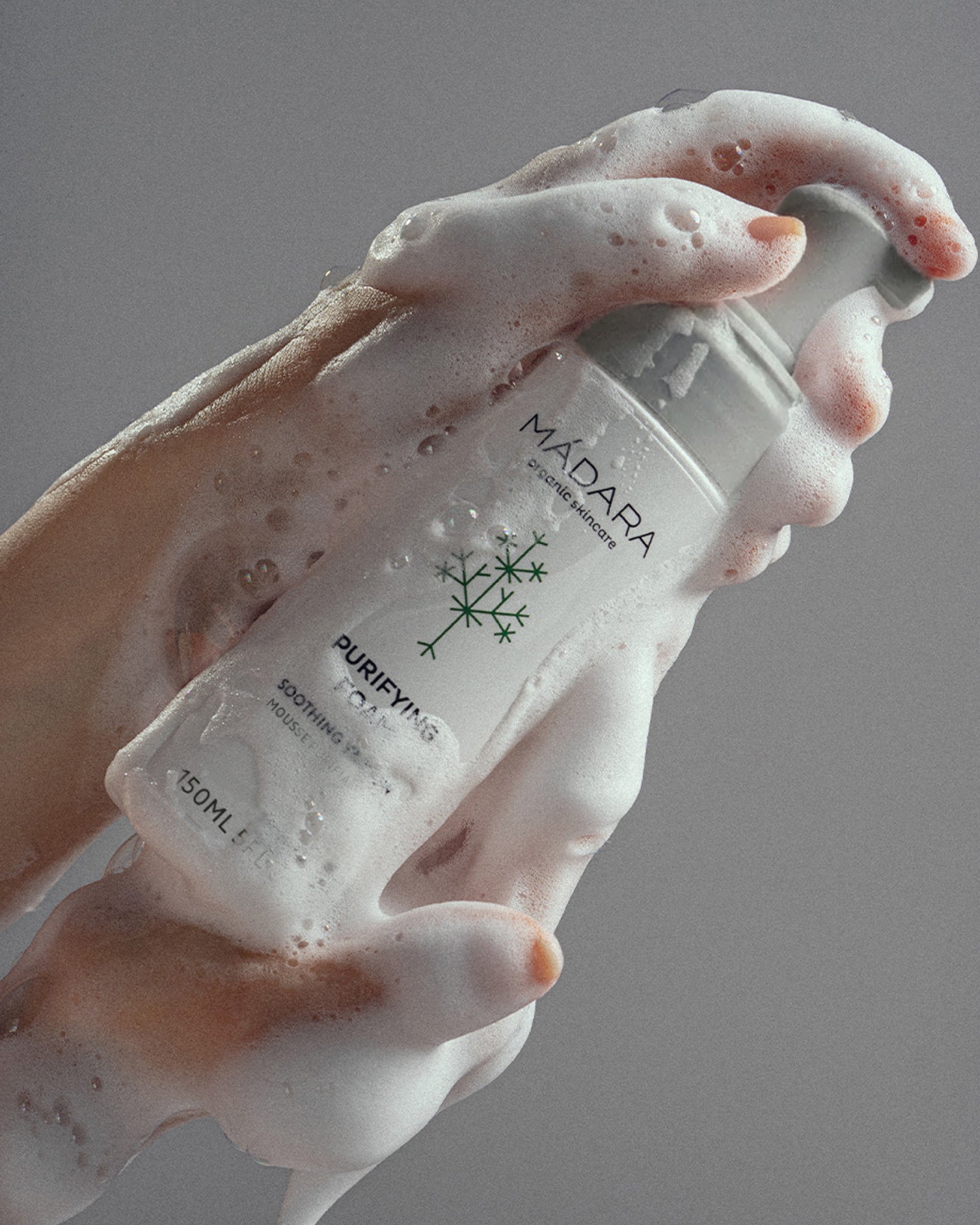 Person holding a Mádara Skincare Purifying Foam
