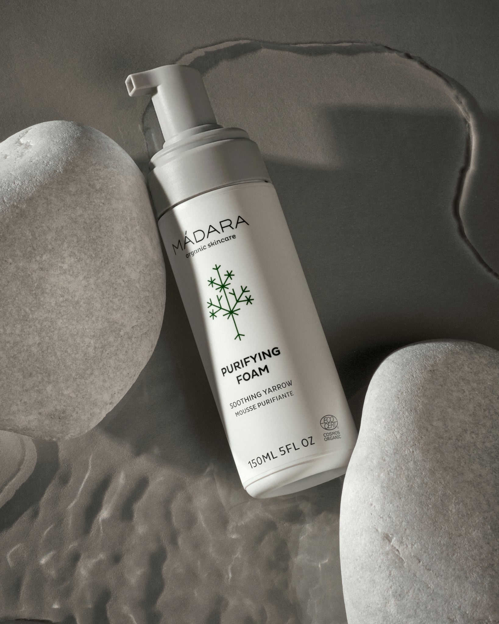 MADARA Purifying Foam bottle on a textured gray background