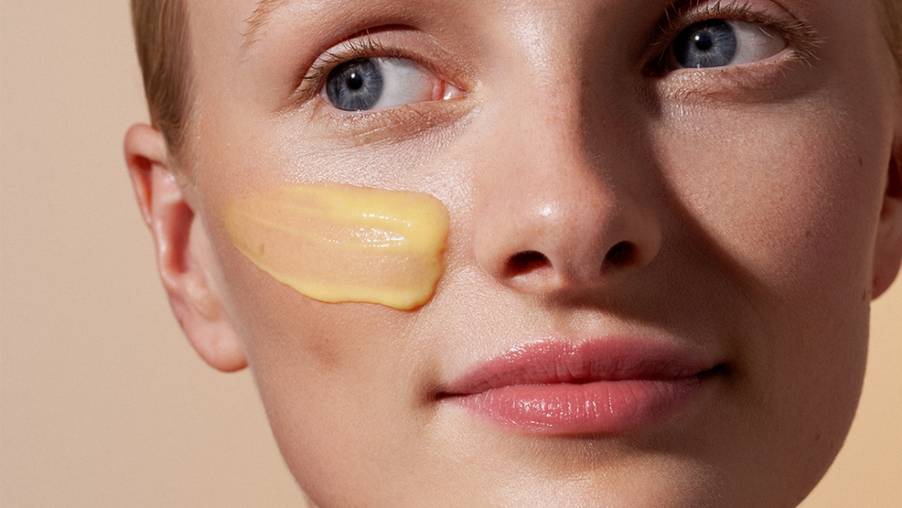 Close-up of VITAMIN C Intense Glow Concentrate model's cheek with the products texture on it