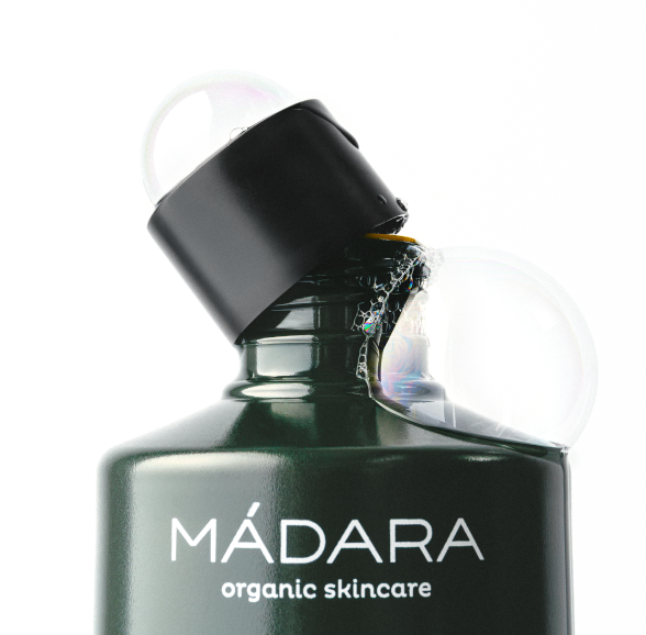 Close-up_of_a_MADARA_grow_shampoo_with_black_cap_and_bubbles