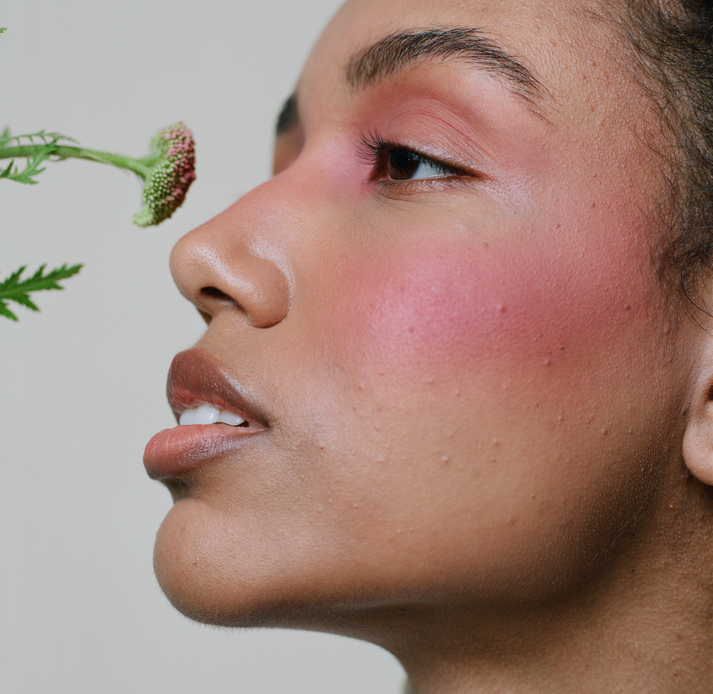 Close-up of a model’s face with soft pink cheeks enhanced by MÁDARA Magnetic Blush Mineral Cheek Blusher, with a natural radiant finish