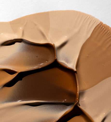 Close-up of foundation shades blended together in creamy swatches