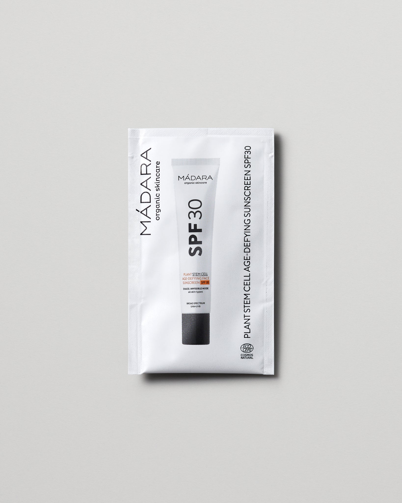 Model wearing MÁDARA Organic Skincare plant stem cell age defying face sunscreen spf30 2ml SC3415 2 mineral sunscreen on skin; close-up portrait shows natural applicat�